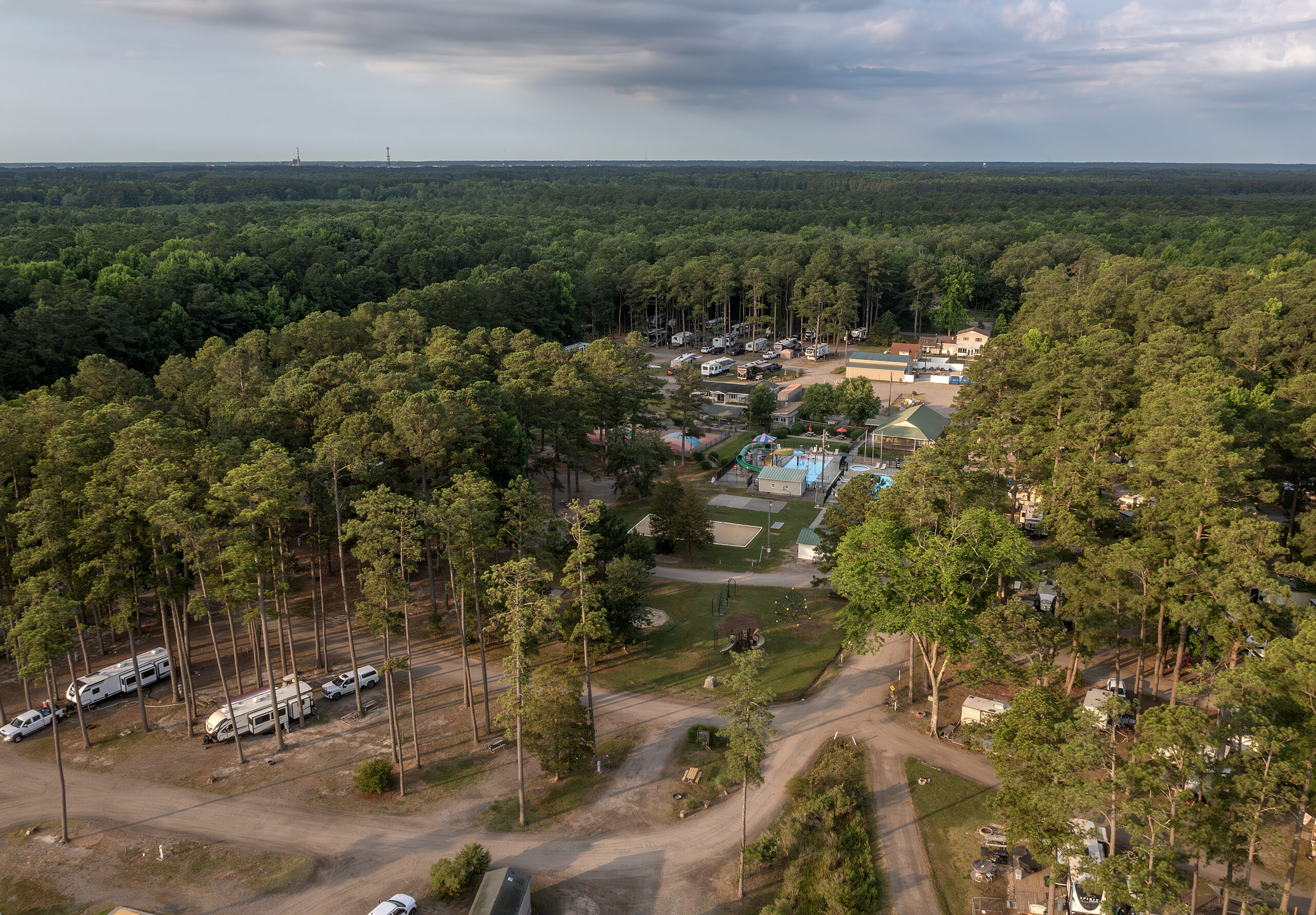 Overhead view of campground showing pool, RVs, and trees