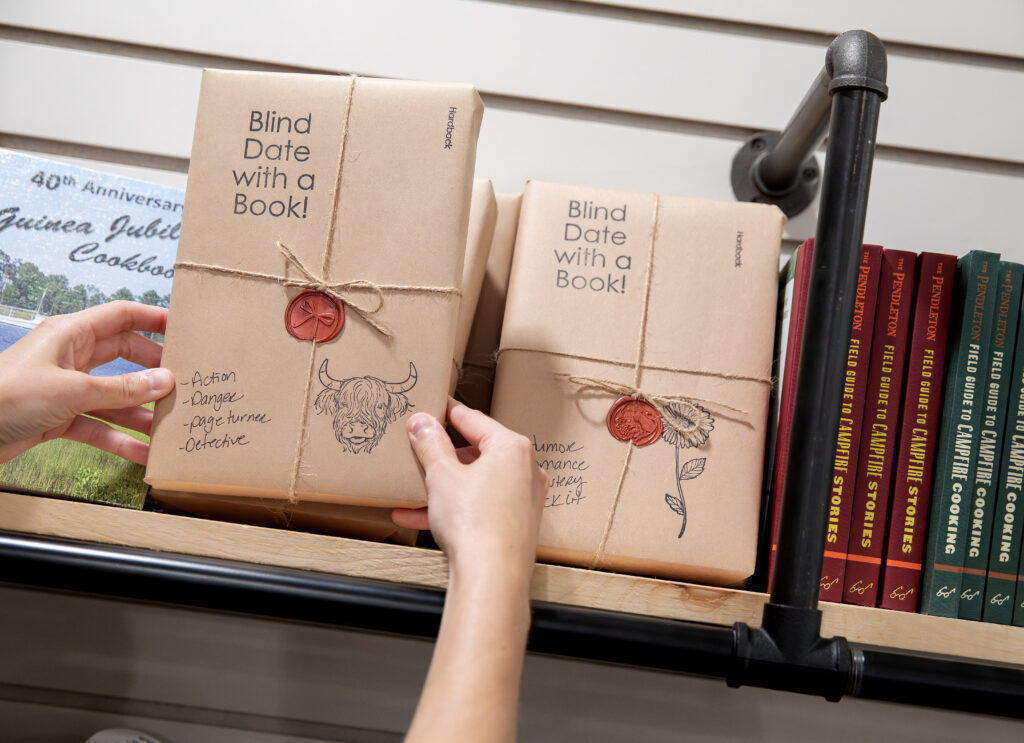 Books wrapped in brown paper labeled “Blind Date with a Book” at Camp Cardinal shop